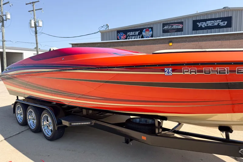  Yacht Photos Pics 2012 DCB 28 Extreme boat with vibrant red and orange design on a trailer.