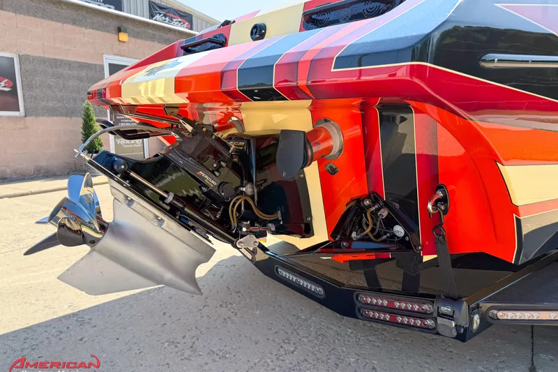  Yacht Photos Pics Rear view of a 2012 DCB 28 Extreme boat with vibrant graphics and Mercury engine.