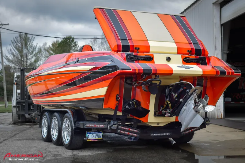  Yacht Photos Pics 2012 DCB 28 Extreme powerboat with vibrant orange and black stripes on a trailer.