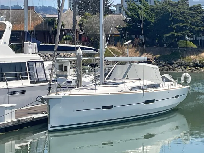 Send Me Yacht Photos Pics 2018 Dufour 460 Grand Large yacht docked in a marina, surrounded by calm water.