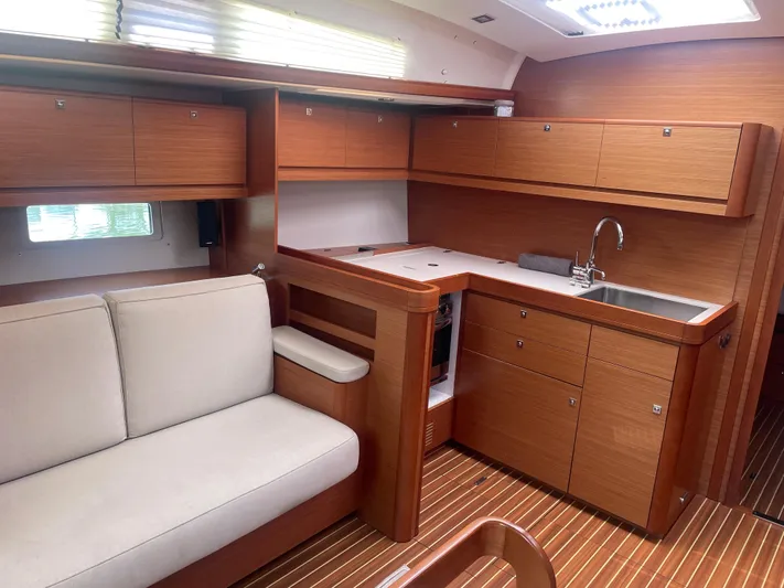 Send Me Yacht Photos Pics Interior of 2018 Dufour 460 Grand Large yacht with modern kitchen and seating area.