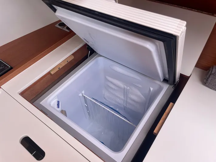Send Me Yacht Photos Pics Open freezer compartment on 2018 Dufour 460 Grand Large yacht, showcasing interior storage space.