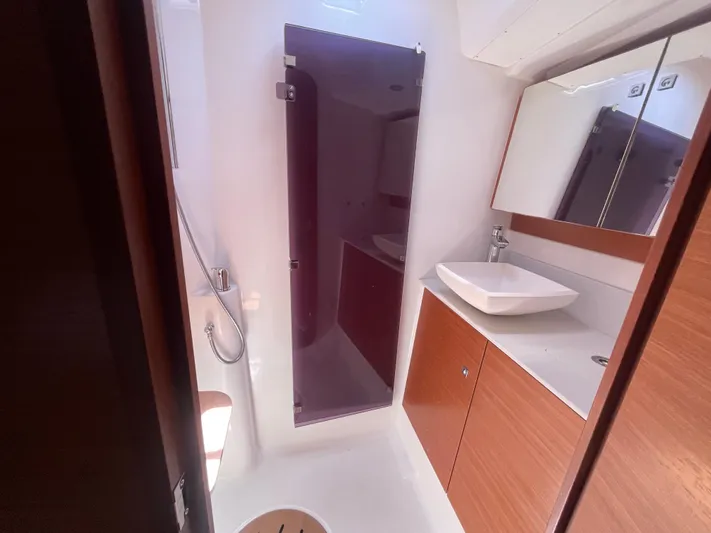 Send Me Yacht Photos Pics Modern bathroom in 2018 Dufour 460 Grand Large yacht with sleek fixtures and wood accents.