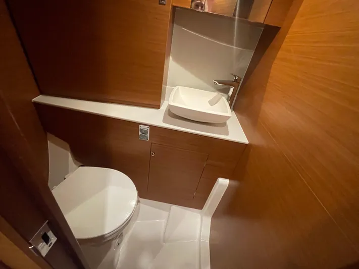Send Me Yacht Photos Pics Bathroom interior of 2018 Dufour 460 Grand Large yacht, featuring modern sink and toilet.