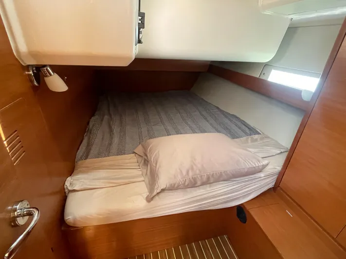 Send Me Yacht Photos Pics Cozy cabin interior of 2018 Dufour 460 Grand Large yacht with bed and wooden finish.