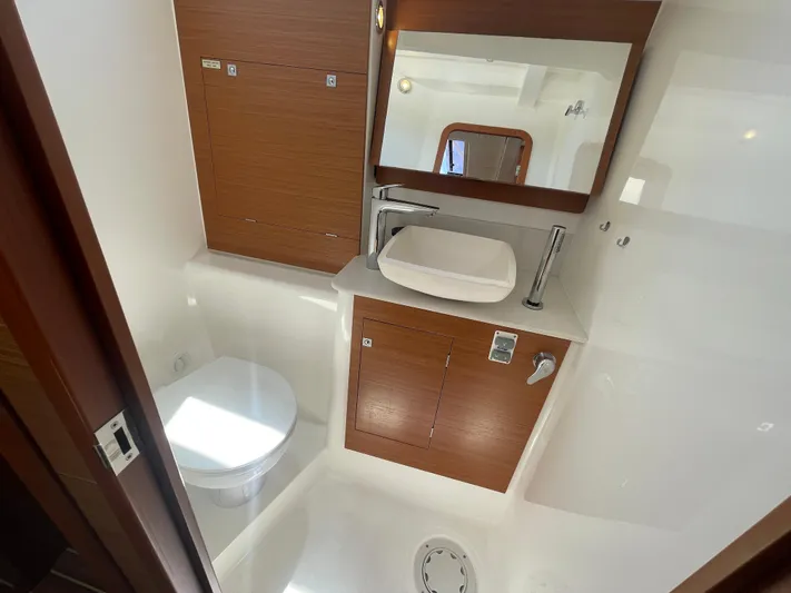 Send Me Yacht Photos Pics Bathroom interior of 2018 Dufour 460 Grand Large yacht, featuring modern fixtures and wood accents.