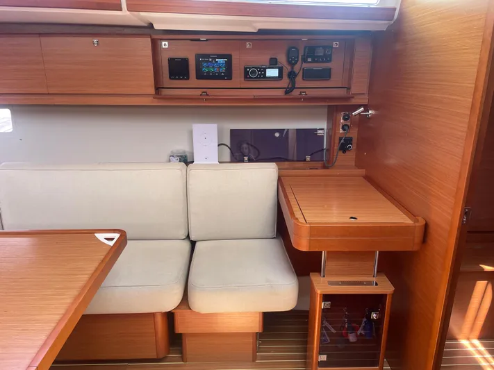 Send Me Yacht Photos Pics Interior of 2018 Dufour 460 Grand Large yacht with wooden cabinetry and beige seating.