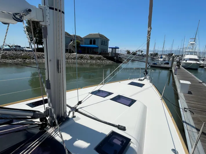 Send Me Yacht Photos Pics Dufour 460 Grand Large 2018 sailboat docked at marina under clear blue sky.