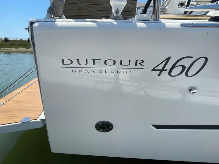 Send Me Yacht Photos Pics 2018 Dufour 460 Grand Large yacht, docked, showcasing sleek design and branding.