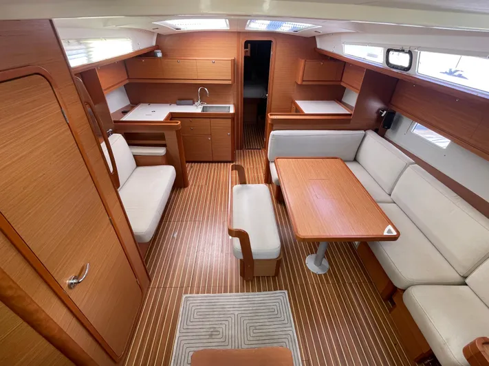 Send Me Yacht Photos Pics Interior of 2018 Dufour 460 Grand Large yacht with wood finish and spacious seating area.