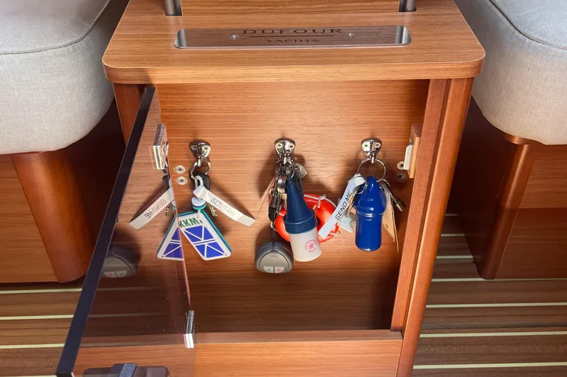 Send Me Yacht Photos Pics Key storage inside a 2018 Dufour 460 Grand Large yacht, featuring organized keychains.
