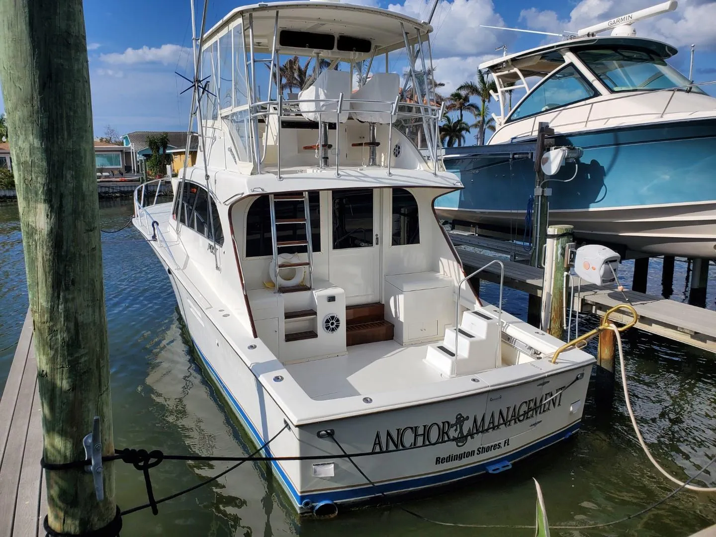 1988 Post 46 Sportfish boat docked in marina, rear view.