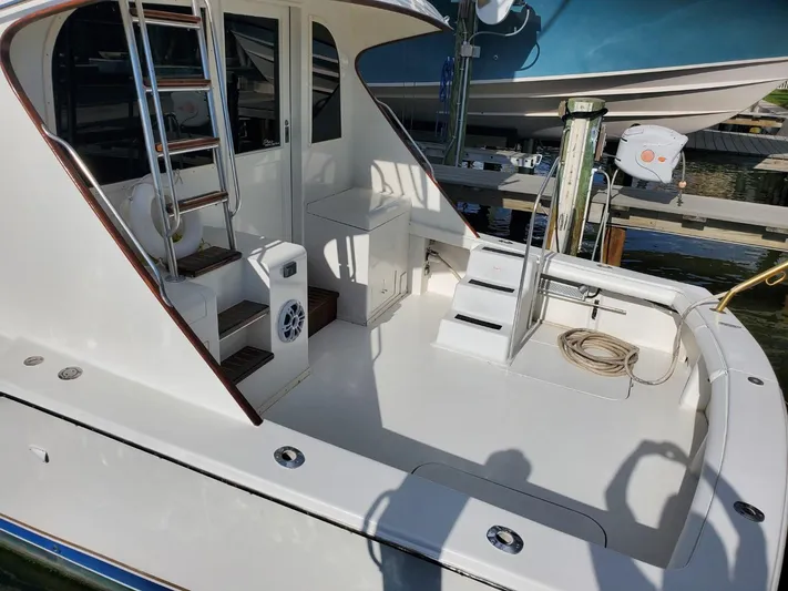 Anchor Management Yacht Photos Pics 1988 Post 46 Sportfish boat deck with ladder and seating area, docked at marina.