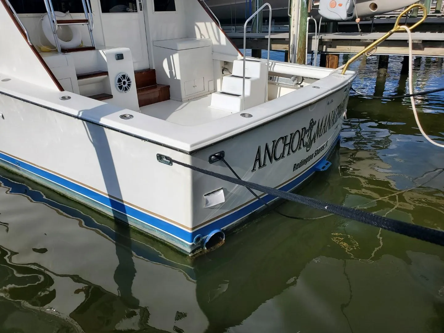 1988 Post 46 Sportfish boat docked, featuring white hull and blue trim.