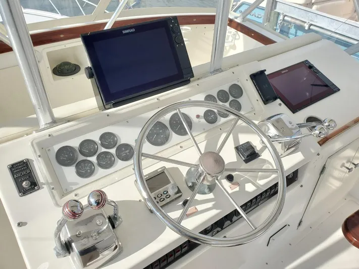 Anchor Management Yacht Photos Pics 1988 Post 46 Sportfish helm with steering wheel, gauges, and navigation screens.