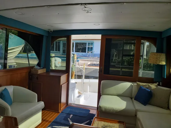 Anchor Management Yacht Photos Pics Interior of 1988 Post 46 Sportfish yacht with cozy seating and large windows.