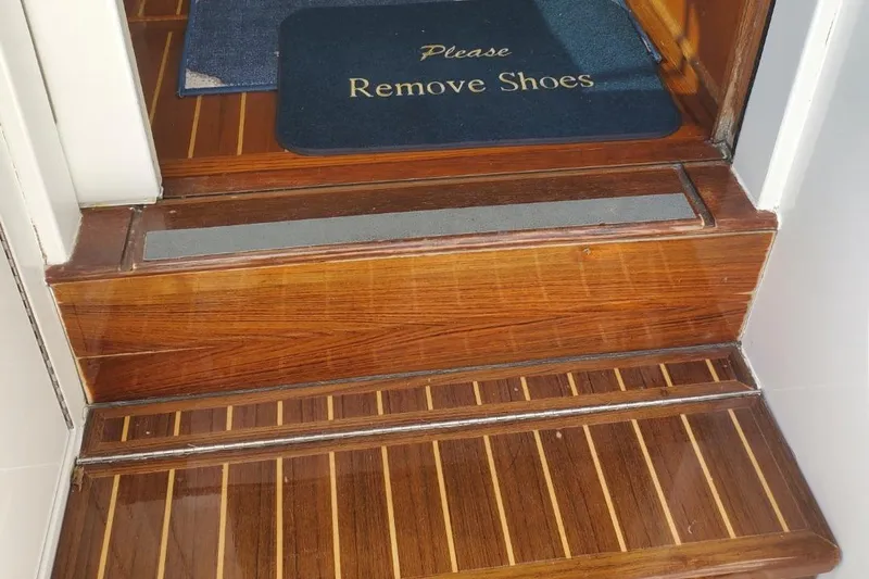 Anchor Management Yacht Photos Pics Wooden steps with "Please Remove Shoes" mat on 1988 Post 46 Sportfish boat.