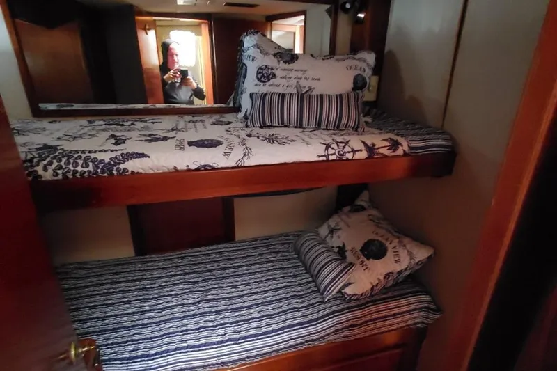 Anchor Management Yacht Photos Pics Bunk beds in 1988 Post 46 Sportfish cabin with nautical-themed bedding.