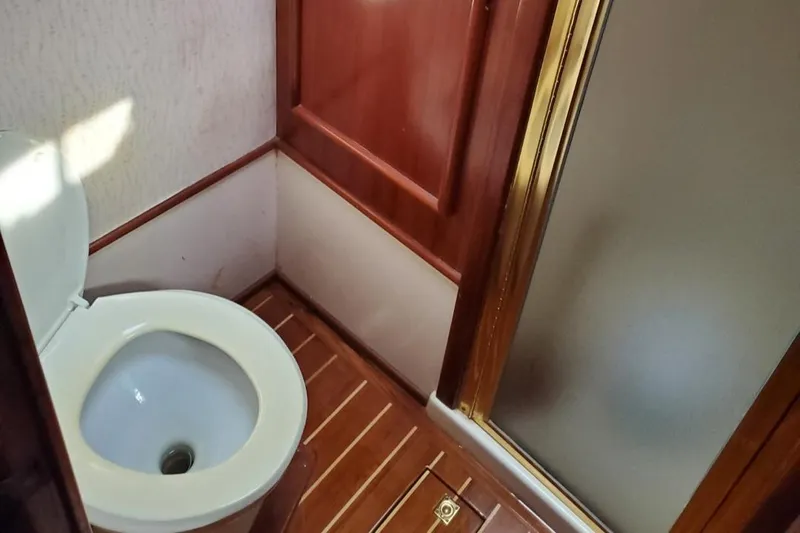 Anchor Management Yacht Photos Pics 1988 Post 46 Sportfish bathroom with wooden flooring and shower.