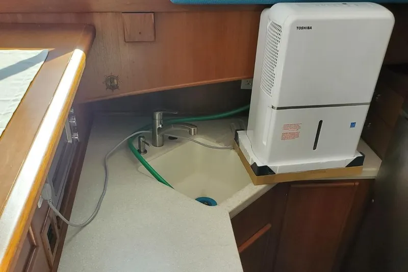 Anchor Management Yacht Photos Pics 1988 Post 46 Sportfish boat kitchen with sink and dehumidifier.