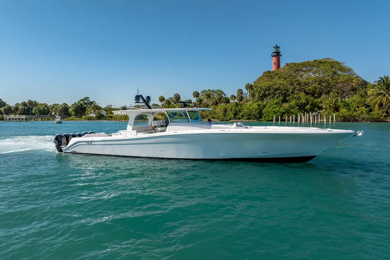  Yacht Photos Pics 2026 HCB 65 Estrella luxury yacht cruising near a scenic lighthouse.