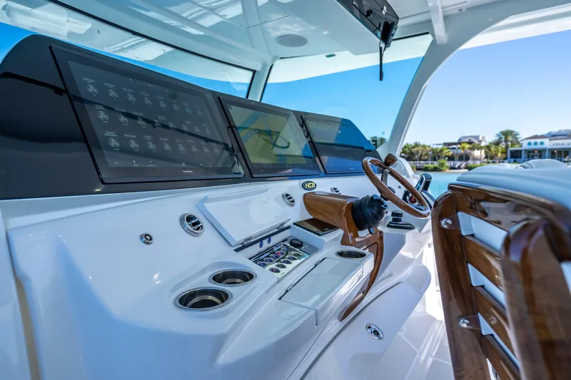  Yacht Photos Pics Helm of 2026 HCB 65 Estrella boat with advanced navigation displays and wooden steering wheel.