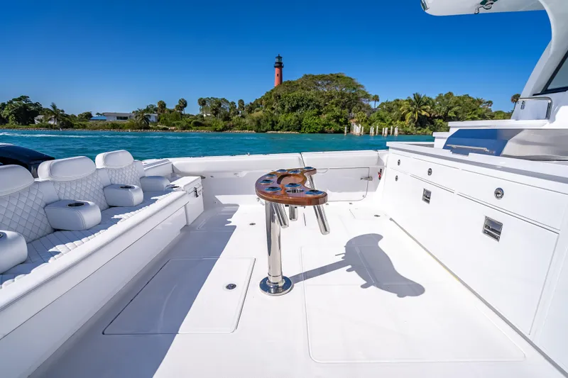  Yacht Photos Pics Luxurious 2026 HCB 65 Estrella yacht deck with seating, table, and scenic ocean view.