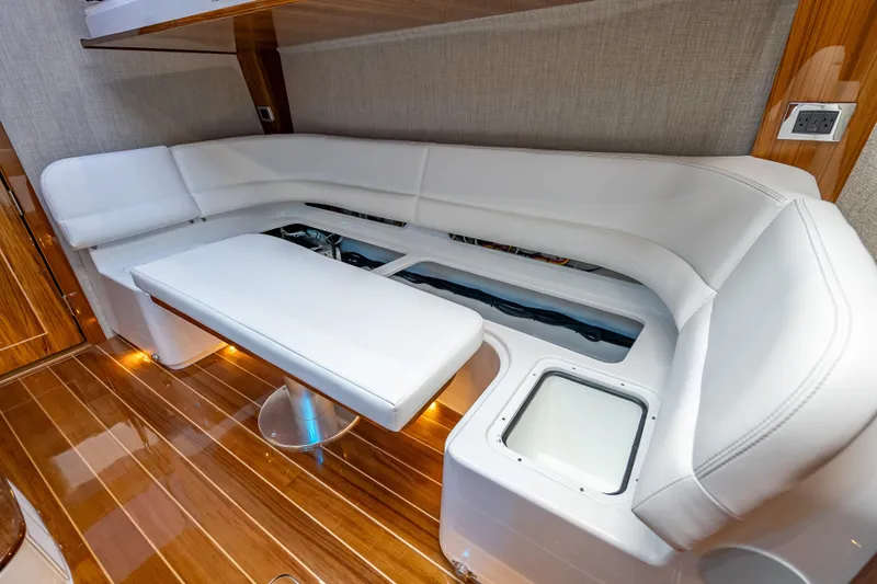  Yacht Photos Pics Luxurious interior of 2026 HCB 65 Estrella yacht with white seating and wooden flooring.
