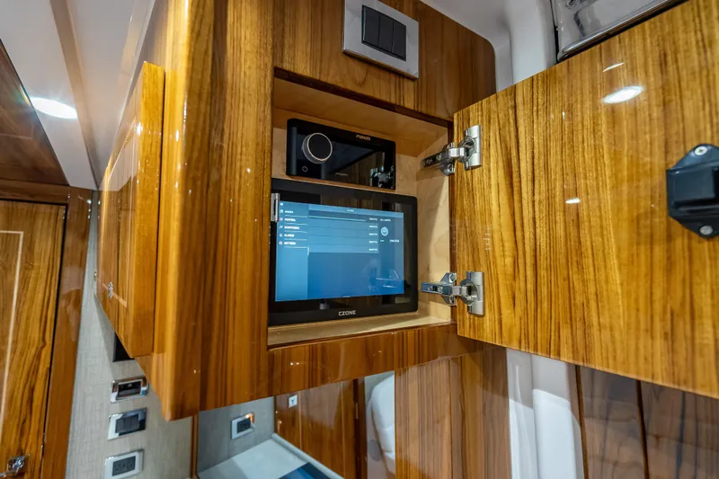  Yacht Photos Pics 2026 HCB 65 Estrella interior with wooden cabinetry and integrated control panel.