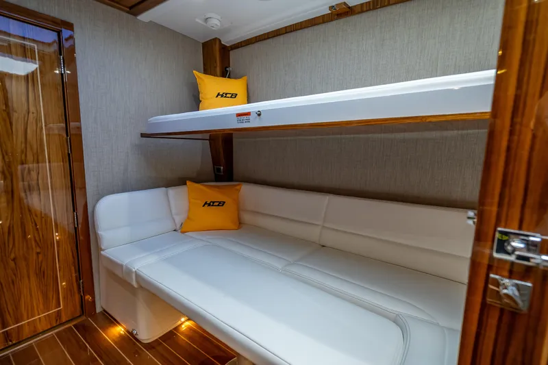  Yacht Photos Pics Luxurious interior of 2026 HCB 65 Estrella yacht with bunk beds and wood accents.