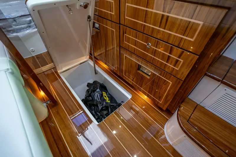  Yacht Photos Pics Luxurious interior of 2026 HCB 65 Estrella yacht with wooden flooring and storage compartment.