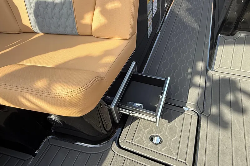  Yacht Photos Pics 2026 MasterCraft XT24 boat interior with tan seating and a pull-out drawer.