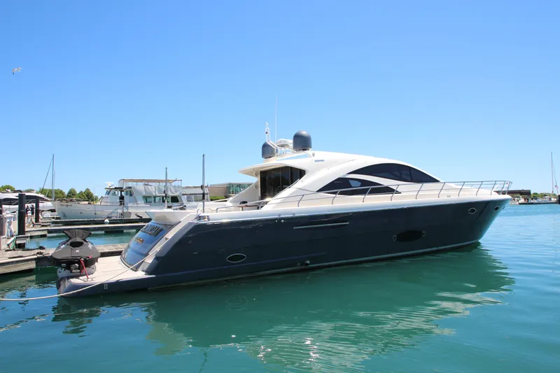  Yacht Photos Pics 2007 Uniesse 70 Sport yacht docked in marina under clear blue sky.