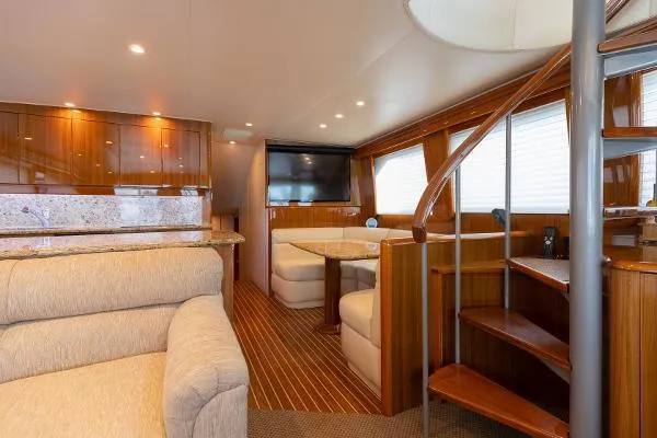 Chona Yacht Photos Pics Luxurious interior of 2007 Viking 64 Enclosed yacht with elegant wood finishes and cozy seating.