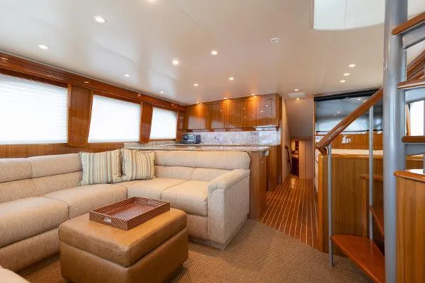 Chona Yacht Photos Pics Luxurious interior of a 2007 Viking 64 Enclosed yacht with plush seating and wooden finishes.