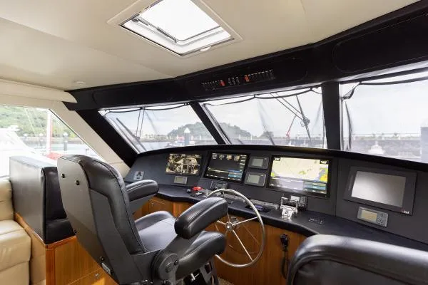 Chona Yacht Photos Pics 2007 Viking 64 Enclosed yacht helm with navigation screens and leather seating.