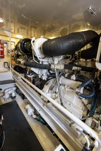 Chona Yacht Photos Pics Engine room of 2007 Viking 64 Enclosed yacht, showcasing complex machinery and piping.