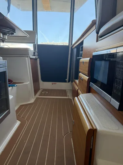  Yacht Photos Pics Interior of 2017 Cutwater C-302 Sport Coupe, featuring wood cabinetry and modern appliances.