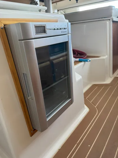  Yacht Photos Pics 2017 Cutwater C-302 Sport Coupe interior with Dometic fridge and wooden flooring.