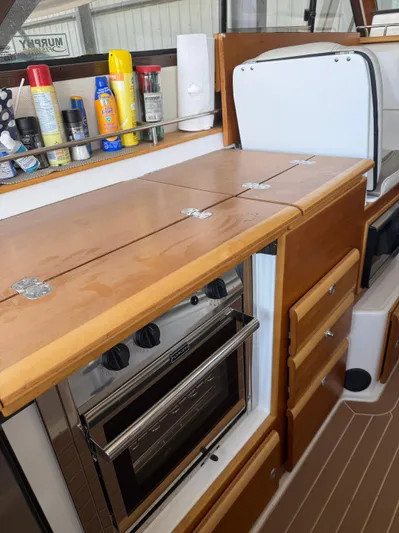  Yacht Photos Pics 2017 Cutwater C-302 Sport Coupe interior kitchen with wooden cabinets and built-in oven.