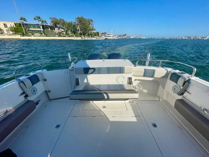  Yacht Photos Pics 2017 Cutwater C-302 Sport Coupe boat interior with seating, on calm water.