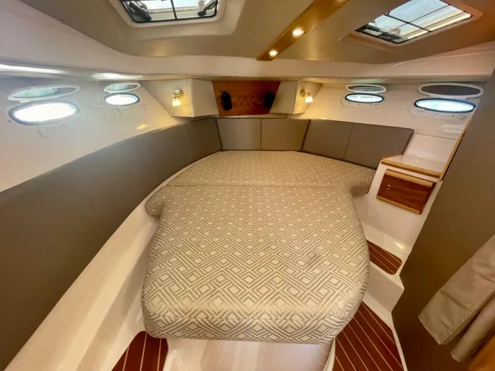  Yacht Photos Pics Interior cabin of 2017 Cutwater C-302 Sport Coupe with cozy bed and porthole windows.