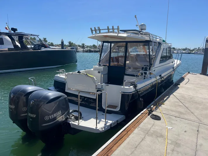  Yacht Photos Pics 2017 Cutwater C-302 Sport Coupe docked, featuring dual Yamaha engines, in a sunny marina setting.