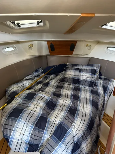  Yacht Photos Pics Cozy cabin interior of 2017 Cutwater C-302 Sport Coupe with plaid bedding.