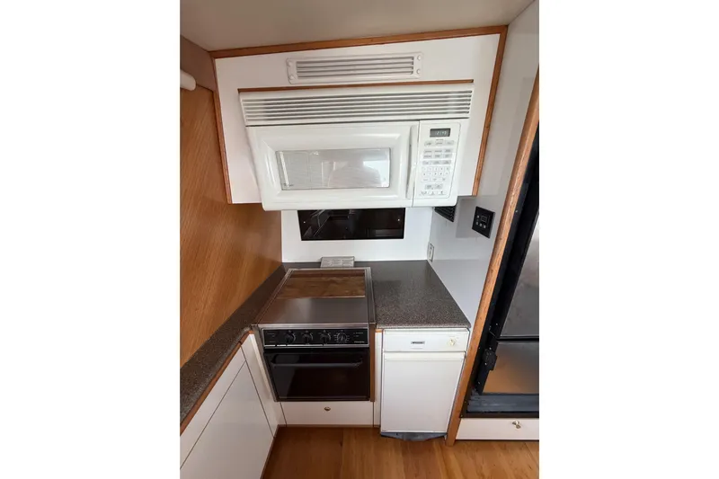 B Liner Yacht Photos Pics 1998 Bayliner 4788 Pilot House Motoryacht kitchen with microwave, oven, and compact design.