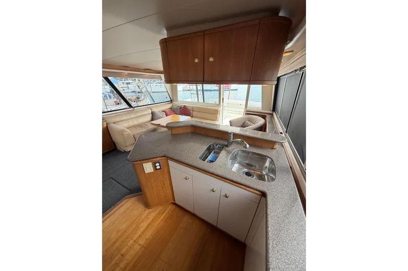B Liner Yacht Photos Pics Interior of 1998 Bayliner 4788 Pilot House Motoryacht with kitchen and seating area.
