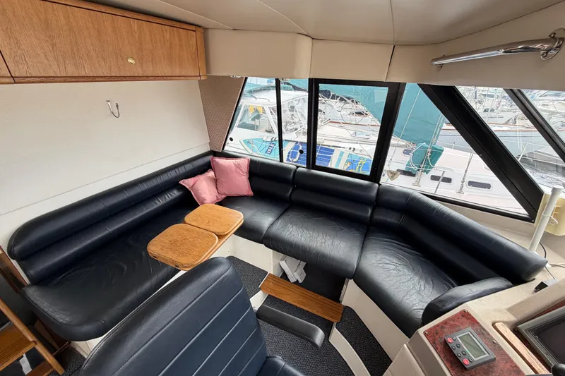 B Liner Yacht Photos Pics Luxurious interior of 1998 Bayliner 4788 Pilot House Motoryacht with leather seating and wood accents.