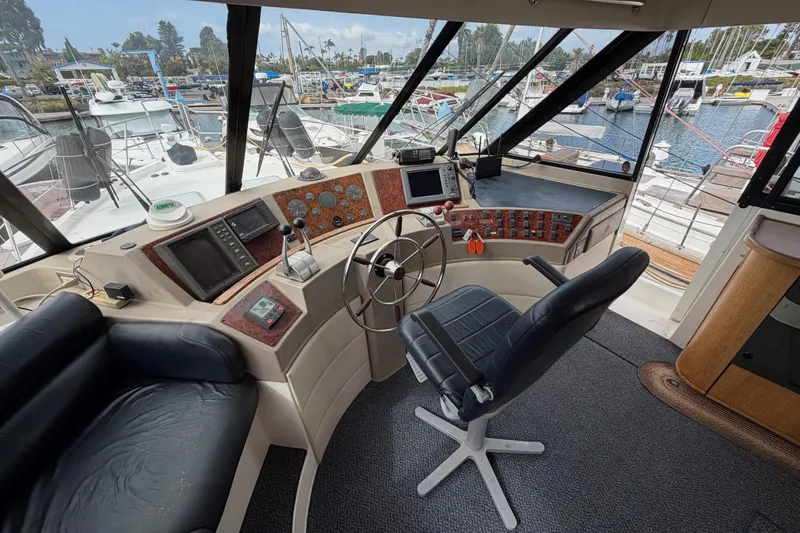 B Liner Yacht Photos Pics Interior of 1998 Bayliner 4788 Pilot House Motoryacht with helm and marina view.