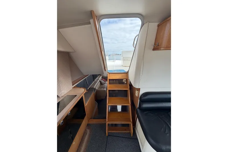 B Liner Yacht Photos Pics Interior view of 1998 Bayliner 4788 Pilot House Motoryacht with wooden stairs and seating.