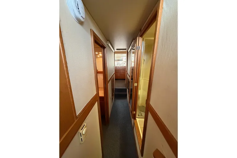 B Liner Yacht Photos Pics 1998 Bayliner 4788 Pilot House Motoryacht interior hallway with wood accents and carpet.